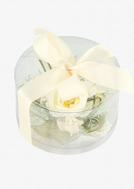 Artificial wedding corsage with ivory faux blooms and fine sprigs in a clear rounded gift box tied with an ivory ribbon bow. For formals, proms and ball occasions. Made in Melbourne by Flowers For Ever After, shipping Australia and Worldwide.