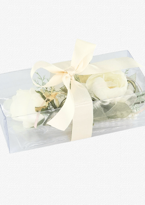 Artificial wedding corsage and boutonniere with ivory faux blooms and fine sprigs in a clear rectangular gift box tied with ivory ribbon. For formals, proms and ball occasions. Made in Melbourne by Flowers For Ever After, shipping Australia and Worldwide.
