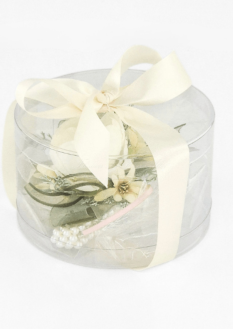 Artificial wedding corsage gift box, reverse view of ivory faux blooms, green leaves, fine sprigs and pearl-style bracelet beneath an ivory bow. For formals, proms and ball occasions. Made in Melbourne by Flowers For Ever After, shipping Australia and Worldwide.