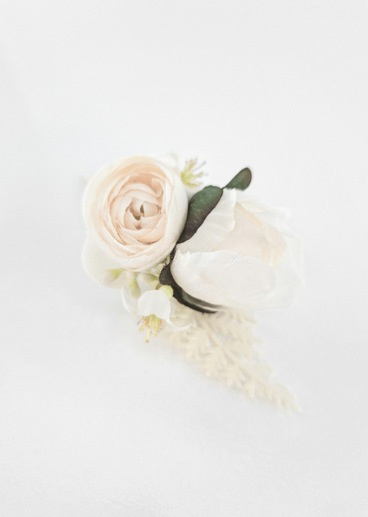 Artificial wedding boutonniere, overhead view of a cream faux peony bud, small ivory bloom, tiny white flowers and green leaves. For formals, proms and ball occasions. Made in Melbourne by Flowers For Ever After, shipping Australia and Worldwide.