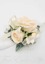 Artificial wedding wrist corsage, side view of cream faux roses, small white flowers and trailing ivory ribbons. For formals, proms and ball occasions. Made in Melbourne by Flowers For Ever After, shipping Australia and Worldwide.