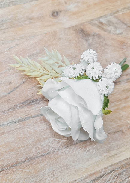 Artificial wedding boutonniere, top view of a white faux rose with small white daisy-like flowers and pale foliage. For formals, proms and ball occasions. Made in Melbourne by Flowers For Ever After, shipping Australia and Worldwide.