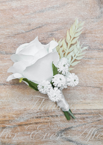 Artificial wedding boutonniere with a white faux rose, small white daisy-like flowers and pale foliage, with wrapped stems. For formals, proms and ball occasions. Made in Melbourne by Flowers For Ever After, shipping Australia and Worldwide.