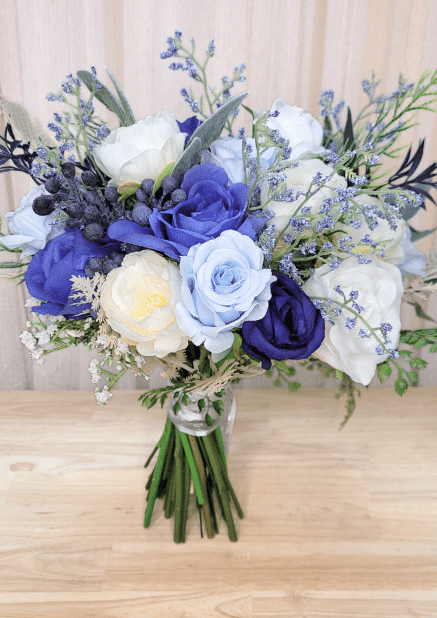Artificial wedding bouquet, reverse view of navy, pale blue and white faux roses, blue berries and fine flower sprigs. Made in Melbourne by Flowers For Ever After, shipping Australia and Worldwide.