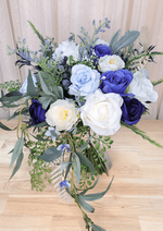 Artificial wedding cascading bouquet, full view of navy, blue and ivory faux roses, white ranunculus and trailing eucalyptus. Made in Melbourne by Flowers For Ever After, shipping Australia and Worldwide.