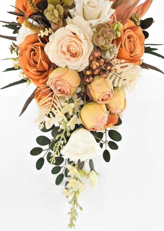 Artificial wedding bouquet detail showing orange and peach faux roses, ivory blooms, bronze berry clusters and trailing cream foliage. Made in Melbourne by Flowers For Ever After, shipping Australia and Worldwide.