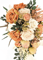 Artificial wedding bouquet close-up with orange and ivory faux roses, peach rosebuds, olive-green hydrangea and dark eucalyptus. Made in Melbourne by Flowers For Ever After, shipping Australia and Worldwide.
