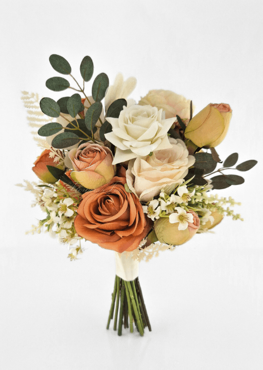 Artificial wedding small bouquet, angled view of orange and ivory faux roses, peach rosebuds and dark eucalyptus. Made in Melbourne by Flowers For Ever After, shipping Australia and Worldwide.