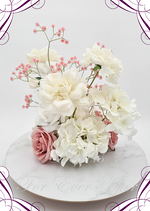 Artificial wedding centrepiece, reverse view of cream blooms, dusty pink faux roses, white hydrangea and tall pink baby's breath sprigs. Made in Melbourne by Flowers For Ever After, shipping Australia and Worldwide.