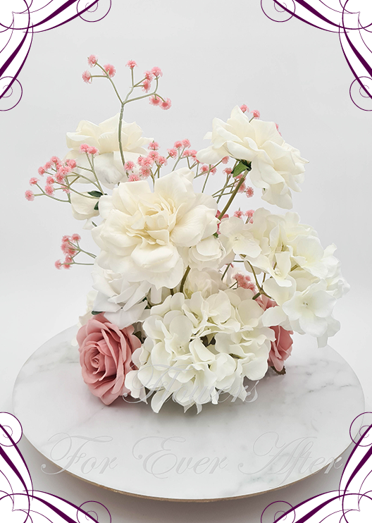 Artificial wedding centrepiece, reverse view of cream blooms, dusty pink faux roses, white hydrangea and tall pink baby's breath sprigs. Made in Melbourne by Flowers For Ever After, shipping Australia and Worldwide.