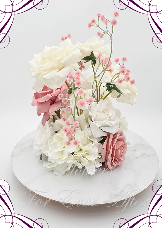 Artificial wedding centrepiece, side view of dusty pink faux roses, white roses, cream blooms, hydrangea and pink baby's breath. Made in Melbourne by Flowers For Ever After, shipping Australia and Worldwide.
