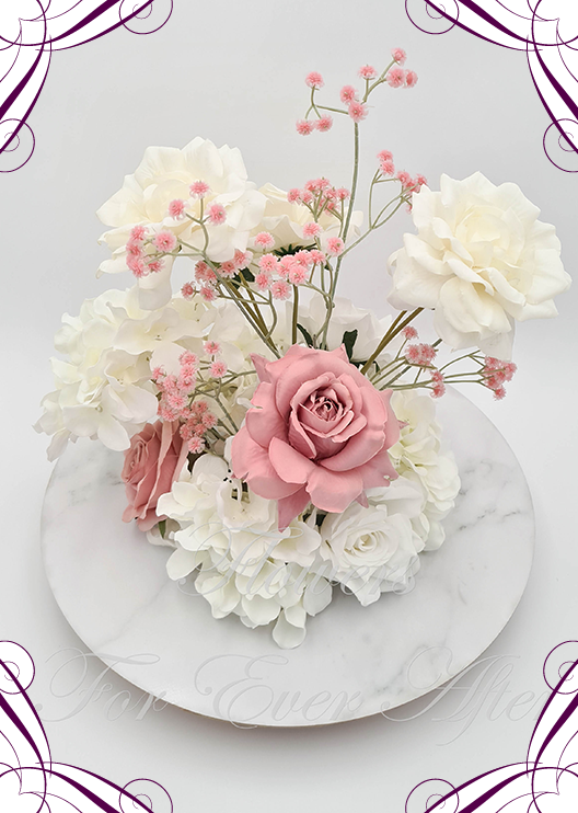 Artificial wedding centrepiece, front view of dusty pink and white faux roses, cream blooms, white hydrangea and pink baby's breath. Made in Melbourne by Flowers For Ever After, shipping Australia and Worldwide.