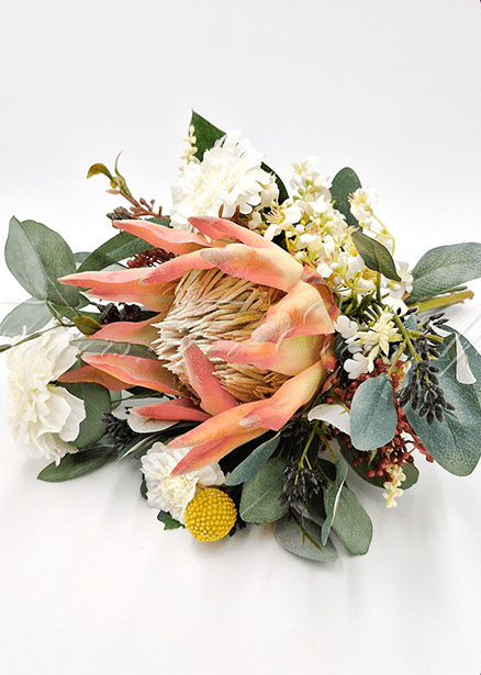 Artificial wedding bridesmaid bouquet, overhead view of a peach faux protea, white flowers and eucalyptus. Made in Melbourne by Flowers For Ever After, shipping Australia and Worldwide.