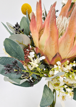 Artificial wedding bridesmaid bouquet close-up showing peach faux protea petals, small white flowers and eucalyptus leaves. Made in Melbourne by Flowers For Ever After, shipping Australia and Worldwide.