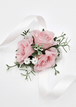 Artificial wedding wrist corsage with pale pink faux roses, small white flowers, green sprigs and trailing ivory ribbons. For formals, proms and ball occasions. Made in Melbourne by Flowers For Ever After, shipping Australia and Worldwide.