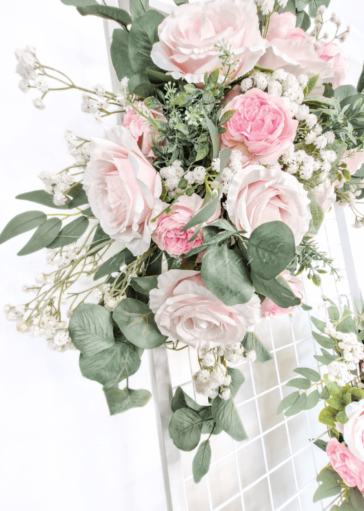Artificial wedding ceremony arrangement, close-up of pale pink faux roses, white pompom flowers and eucalyptus. Made in Melbourne by Flowers For Ever After, shipping Australia and Worldwide.