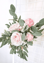 Artificial wedding sign flower arrangement close-up with pale pink faux roses, white blooms and eucalyptus leaves. Made in Melbourne by Flowers For Ever After, shipping Australia and Worldwide.