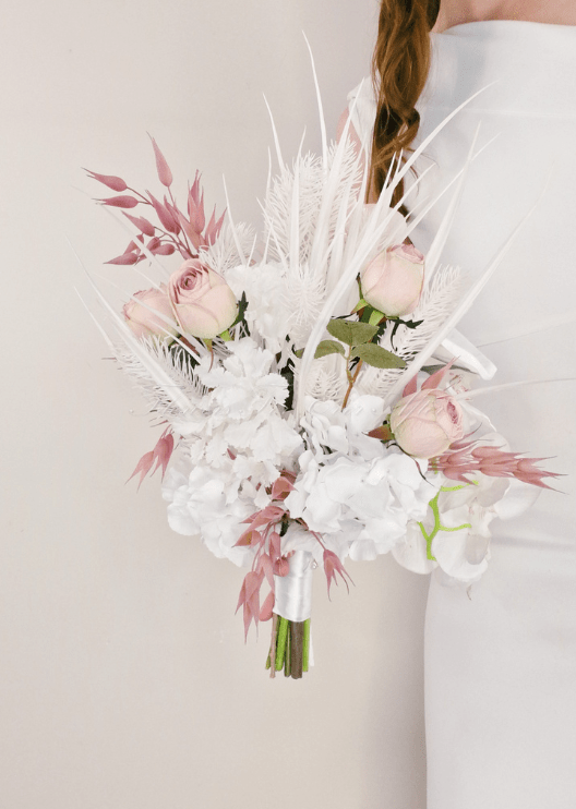 Artificial wedding bridal bouquet close-up showing blush faux roses, red blooms, white orchids and white feathery accents. Made in Melbourne by Flowers For Ever After, shipping Australia and Worldwide.