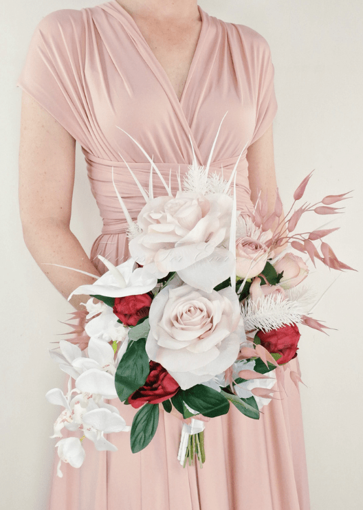 Artificial wedding bridal bouquet, reverse view of blush faux roses, red flowers, white orchids and pink foliage. Made in Melbourne by Flowers For Ever After, shipping Australia and Worldwide.
