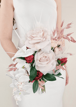 Artificial wedding cascading bridal bouquet with blush faux roses, red flowers, white orchids, pink foliage and white feathery accents. Made in Melbourne by Flowers For Ever After, shipping Australia and Worldwide.