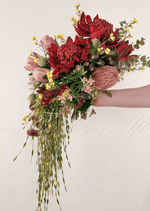 Artificial wedding cascading bridal bouquet, side view of red faux waratah, pink protea, yellow flowers and trailing greenery. Made in Melbourne by Flowers For Ever After, shipping Australia and Worldwide.