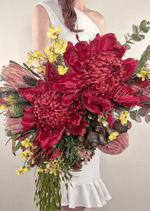 Artificial wedding bridal bouquet close-up with red faux waratah, pink protea, yellow flowers, eucalyptus and dark seed pods. Made in Melbourne by Flowers For Ever After, shipping Australia and Worldwide.