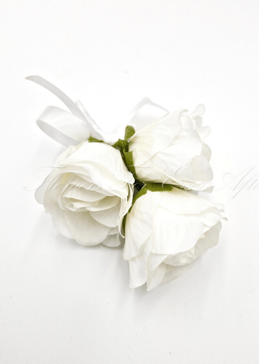 Artificial wedding pin corsage, top view of three white faux roses, green sepals and a white ribbon bow. For formals, proms and ball occasions. Made in Melbourne by Flowers For Ever After, shipping Australia and Worldwide.
