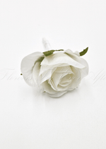 Artificial wedding boutonniere, top view of a white faux rosebud and green sepals. For formals, proms and ball occasions. Made in Melbourne by Flowers For Ever After, shipping Australia and Worldwide.