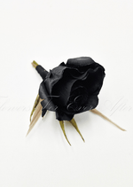 Artificial wedding boutonniere, top view of a black faux rosebud and green sepals. For formals, proms and ball occasions. Made in Melbourne by Flowers For Ever After, shipping Australia and Worldwide.