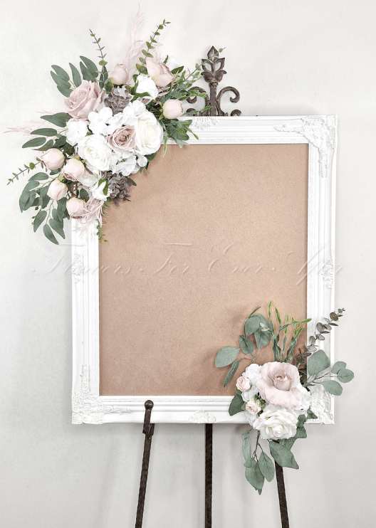 Artificial wedding sign display with two clusters of blush and white faux roses, white hydrangea and eucalyptus at opposite corners. Made in Melbourne by Flowers For Ever After, shipping Australia and Worldwide.
