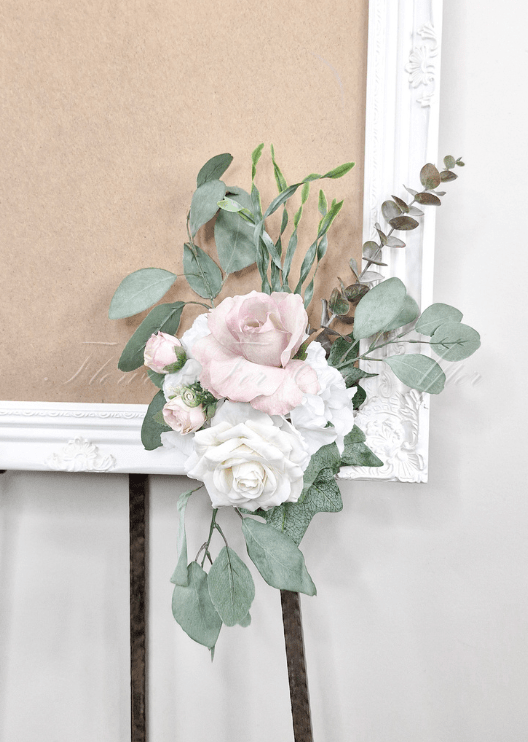 Artificial wedding sign decoration with a blush faux rose, white rose, white hydrangea and eucalyptus at the lower corner. Made in Melbourne by Flowers For Ever After, shipping Australia and Worldwide.