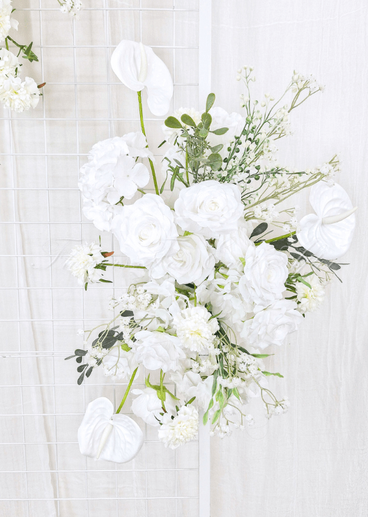 Artificial wedding ceremony floral close-up showing layered faux flower petals and trailing green sprigs. Made in Melbourne by Flowers For Ever After, shipping Australia and Worldwide.