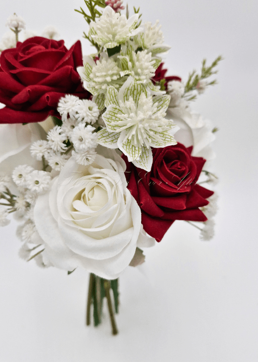 Artificial wedding bridesmaid posy, angled view of burgundy and white faux flowers and green leaves. Made in Melbourne by Flowers For Ever After, shipping Australia and Worldwide.