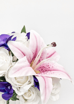 Artificial wedding bridal bouquet, angled view of pink faux lilies, purple orchids and green foliage. Made in Melbourne by Flowers For Ever After, shipping Australia and Worldwide.