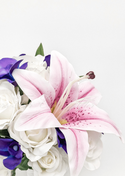 Artificial wedding bridal bouquet, angled view of pink faux lilies, purple orchids and green foliage. Made in Melbourne by Flowers For Ever After, shipping Australia and Worldwide.