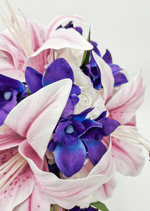 Artificial wedding bridesmaid posy, front view of pink faux lilies, purple orchids and green foliage. Made in Melbourne by Flowers For Ever After, shipping Australia and Worldwide.