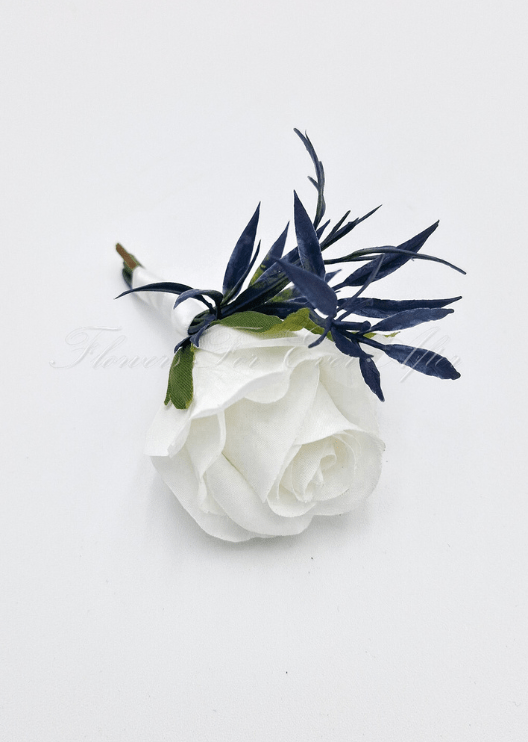 Artificial wedding boutonniere, top view of a white faux rose, small blooms and green foliage. For formals, proms and ball occasions. Made in Melbourne by Flowers For Ever After, shipping Australia and Worldwide.