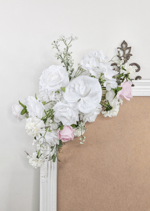 Artificial wedding sign decoration close-up with white faux roses, pale pink roses, white blooms and branching white sprigs. Made in Melbourne by Flowers For Ever After, shipping Australia and Worldwide.
