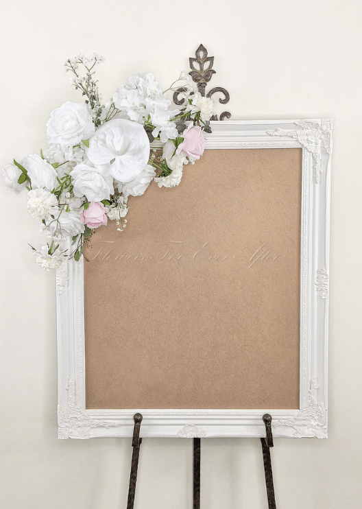 Artificial wedding sign decoration with white faux roses, pale pink roses, white blooms and branching white sprigs at the upper corner. Made in Melbourne by Flowers For Ever After, shipping Australia and Worldwide.