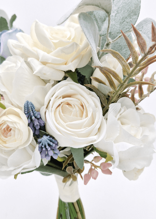 Artificial wedding bridesmaid bouquet, reverse view of cream and dusty blue faux roses, eucalyptus, pink berries and burgundy foliage. Made in Melbourne by Flowers For Ever After, shipping Australia and Worldwide.