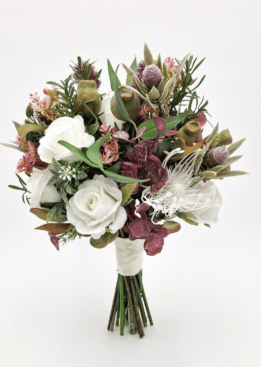 Artificial wedding bridesmaid bouquet with native-style faux blooms, small flowers and green foliage. Made in Melbourne by Flowers For Ever After, shipping Australia and Worldwide.
