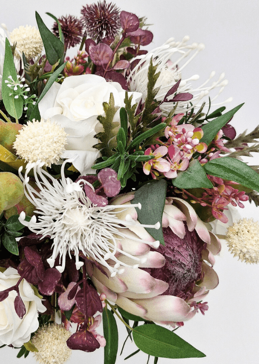 Artificial wedding bridal bouquet with native-style faux blooms, green foliage and exposed stems. Made in Melbourne by Flowers For Ever After, shipping Australia and Worldwide.