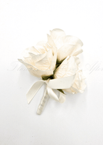 Artificial wedding pin corsage with three cream faux roses, green sepals, an ivory ribbon bow and wrapped stems. For formals, proms and ball occasions. Made in Melbourne by Flowers For Ever After, shipping Australia and Worldwide.