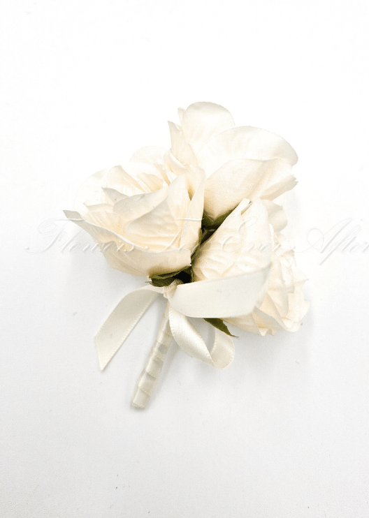 Artificial wedding pin corsage with three cream faux roses, green sepals, an ivory ribbon bow and wrapped stems. For formals, proms and ball occasions. Made in Melbourne by Flowers For Ever After, shipping Australia and Worldwide.