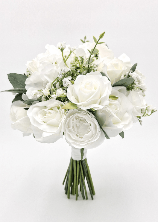 Artificial wedding bridesmaid bouquet with white faux roses, white blooms, fine white filler flowers and eucalyptus leaves. Made in Melbourne by Flowers For Ever After, shipping Australia and Worldwide.