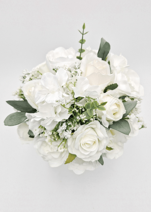 Artificial wedding bridesmaid bouquet, top view of white faux roses, white blooms, fine filler flowers and eucalyptus. Made in Melbourne by Flowers For Ever After, shipping Australia and Worldwide.