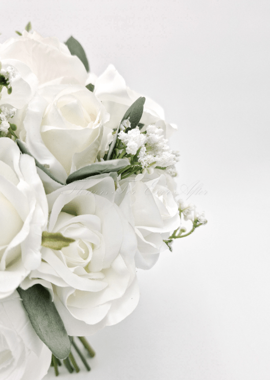 Artificial wedding bouquet close-up showing white faux roses, white blooms, small filler flowers and eucalyptus. Made in Melbourne by Flowers For Ever After, shipping Australia and Worldwide.