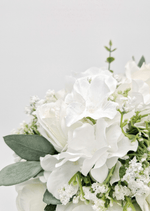 Artificial wedding bouquet close-up with white faux roses, white blooms and fine white sprigs among eucalyptus leaves. Made in Melbourne by Flowers For Ever After, shipping Australia and Worldwide.