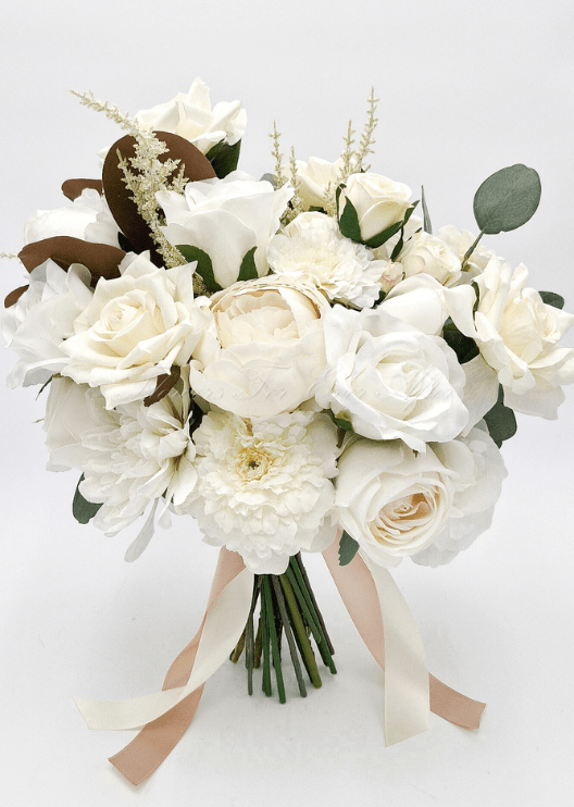 Artificial wedding bridal bouquet with ivory faux roses, pale ranunculus, white peonies, eucalyptus, brown magnolia leaves and trailing ribbons. Made in Melbourne by Flowers For Ever After, shipping Australia and Worldwide.