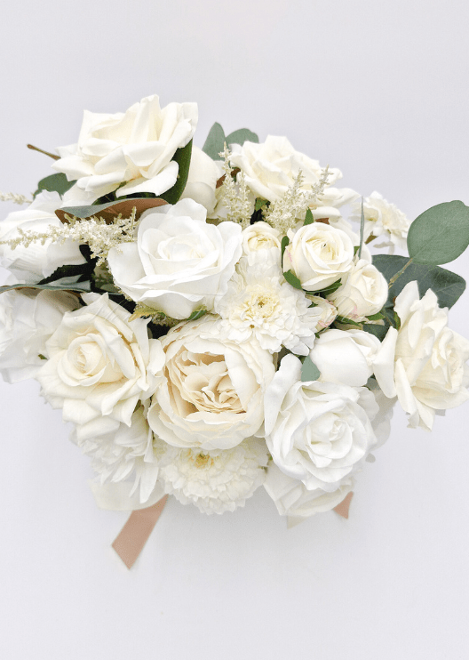 Artificial wedding bridal bouquet, overhead view of ivory faux roses, pale blooms, eucalyptus and brown magnolia leaves. Made in Melbourne by Flowers For Ever After, shipping Australia and Worldwide.
